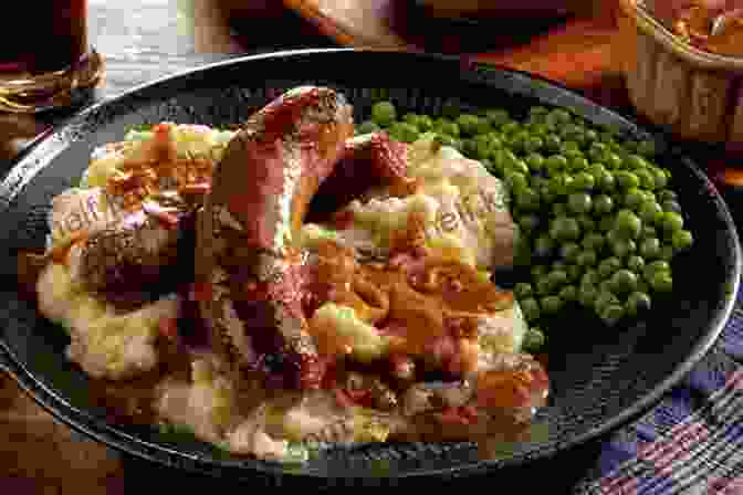 A Comforting Plate Of British Bangers And Mash, Featuring Juicy Sausages And Creamy Mashed Potatoes. Eating For England: The Delights And Eccentricities Of The British At Table